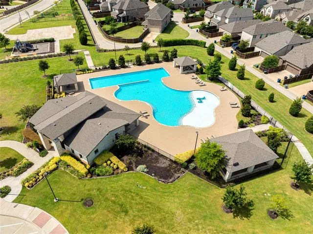 an aerial view of a house with swimming pool garden and outdoor seating