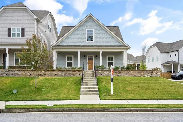 a view of house that has a yard