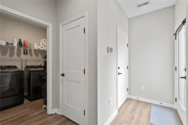 a view of a livingroom with wooden floor and closet