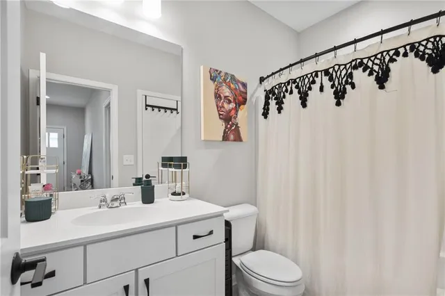 a bathroom with a sink a toilet and a mirror