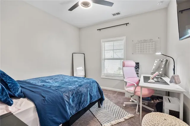 a bedroom with bed and a chair