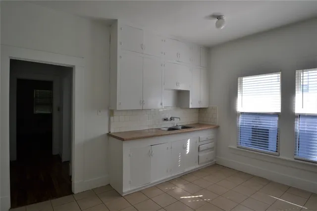a kitchen with granite countertop a sink a window and stainless steel appliances