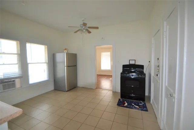 a kitchen with a refrigerator and a stove