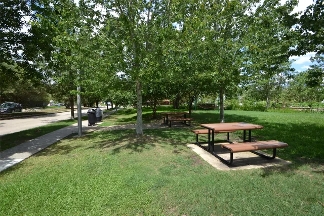 a view of a bench in the garden near a lake