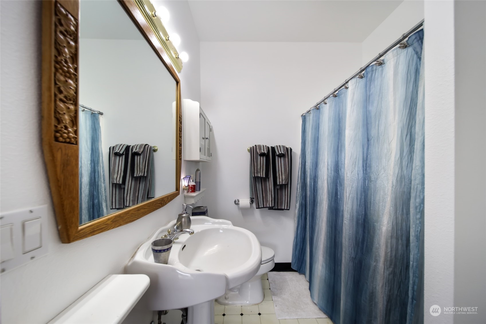 17141 Longmire Road Southeast Yelm, WA 98597 - Photo 16 of 29 a bathroom with a sink a toilet and shower curtain