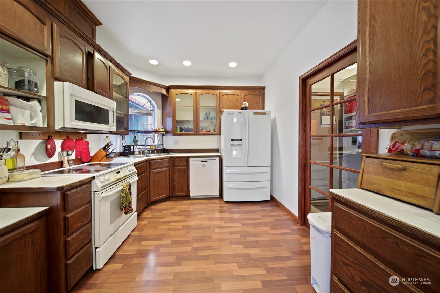17141 Longmire Road Southeast Yelm, WA 98597 - Photo 2 of 29 a kitchen with a sink stove and cabinets