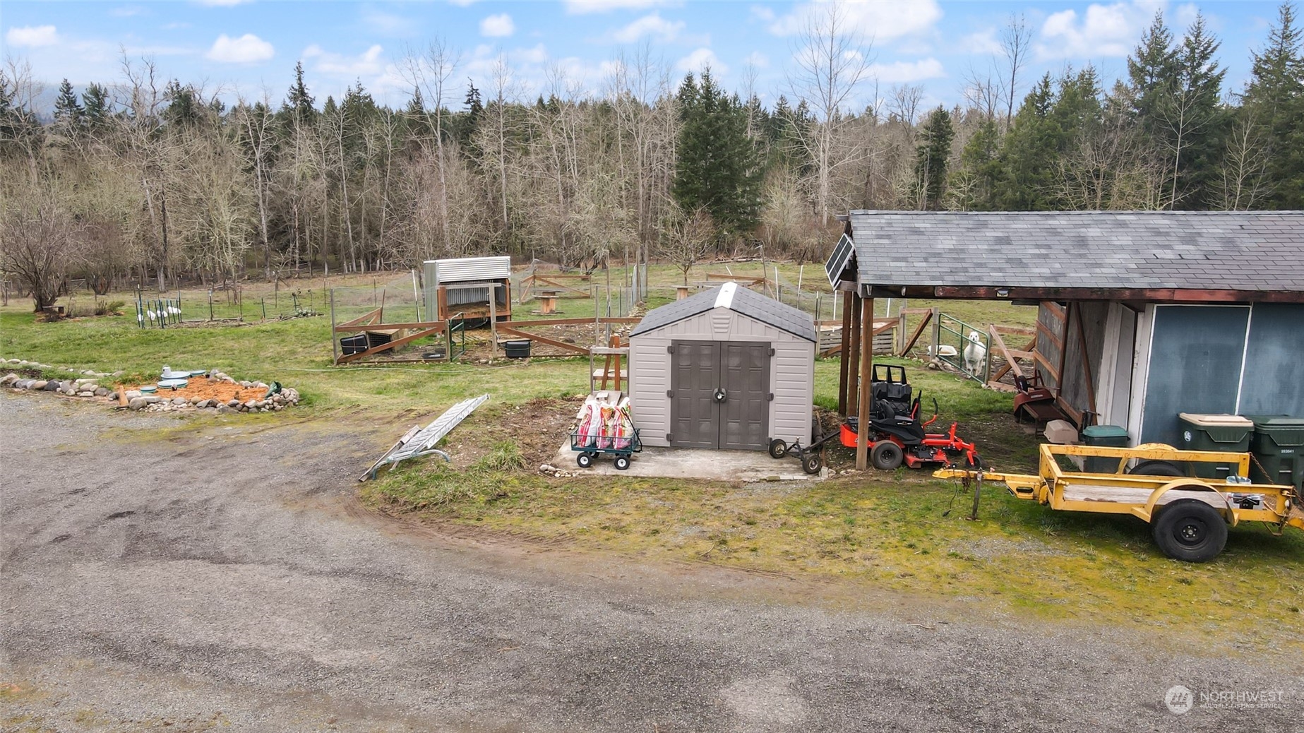 17141 Longmire Road Southeast Yelm, WA 98597 - Photo 25 of 29 a view of a house with a garden and a car parked in it