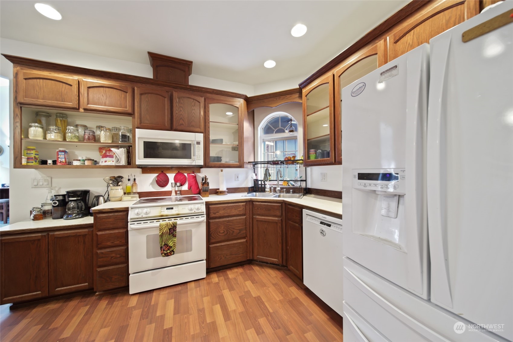 17141 Longmire Road Southeast Yelm, WA 98597 - Photo 3 of 29 a kitchen with a sink stove and cabinets