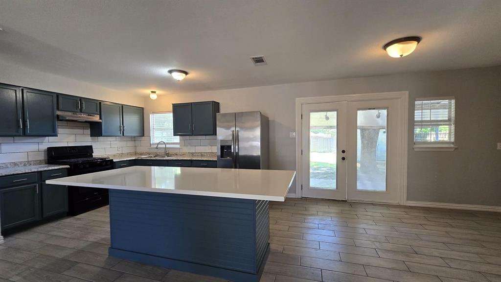 636 Highfall Drive Dallas, TX 75232 - Photo 3 of 14 a large kitchen with stainless steel appliances granite countertop a sink and a granite counter tops