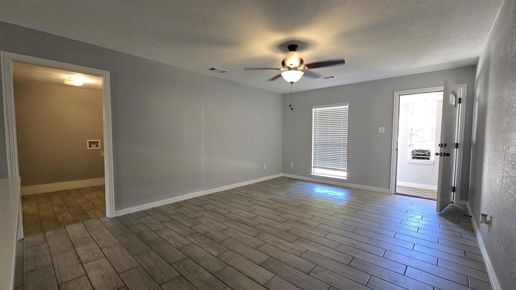 636 Highfall Drive Dallas, TX 75232 - Photo 6 of 14 an empty room with wooden floor and ceiling fan