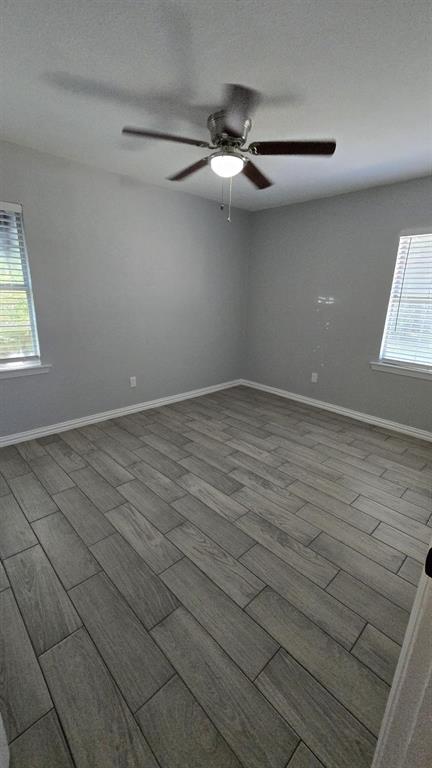 636 Highfall Drive Dallas, TX 75232 - Photo 8 of 14 an empty room with windows and fan