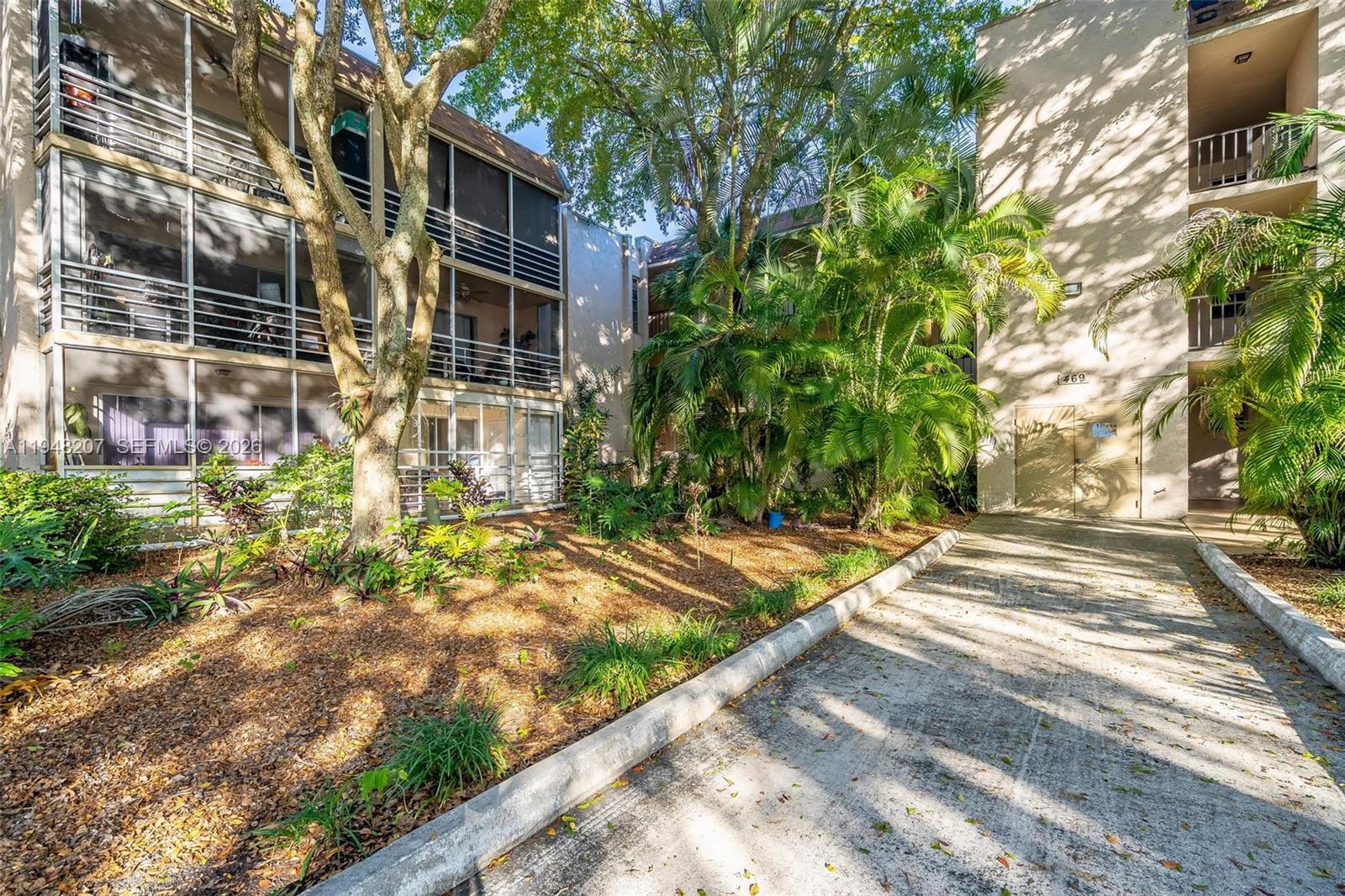 469 North Pine Island Road, Unit B302 Plantation, FL 33324 - Photo 2 of 33 a view of a yard with plants and large trees