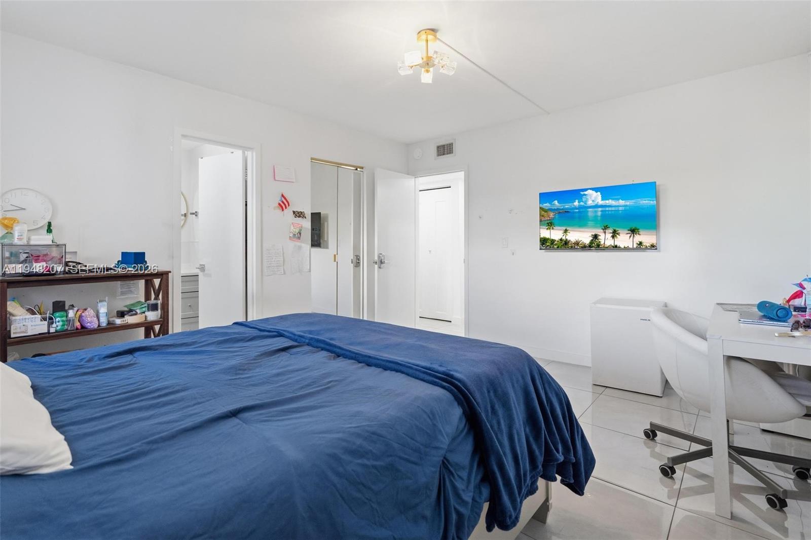 469 North Pine Island Road, Unit B302 Plantation, FL 33324 - Photo 21 of 33 a bedroom with a bed and a table in it