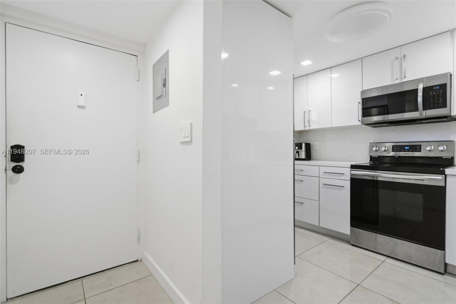 469 North Pine Island Road, Unit B302 Plantation, FL 33324 - Photo 5 of 33 a kitchen with stainless steel appliances granite countertop a refrigerator and a stove top oven