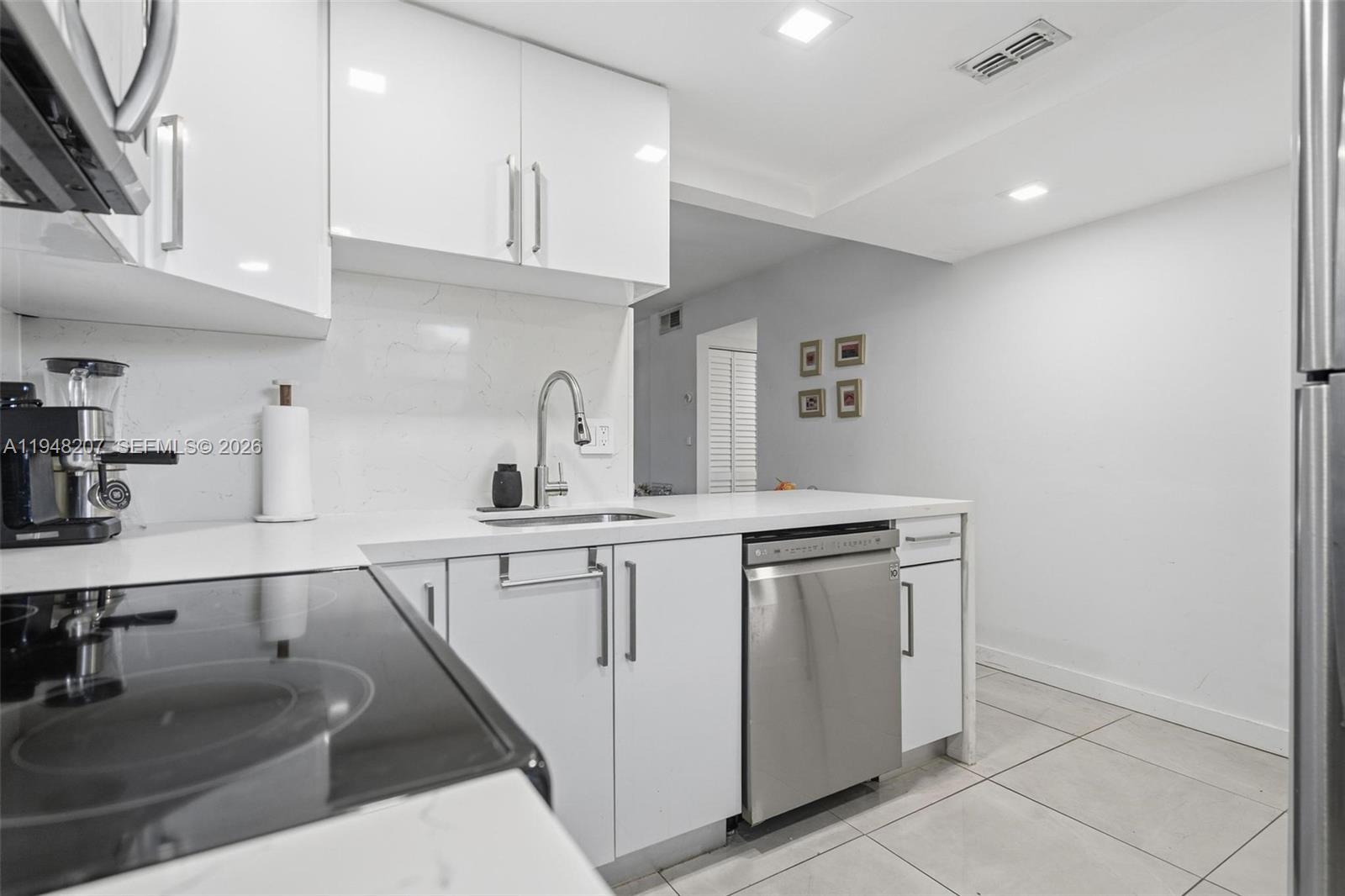 469 North Pine Island Road, Unit B302 Plantation, FL 33324 - Photo 9 of 33 a kitchen with cabinets a sink and appliances