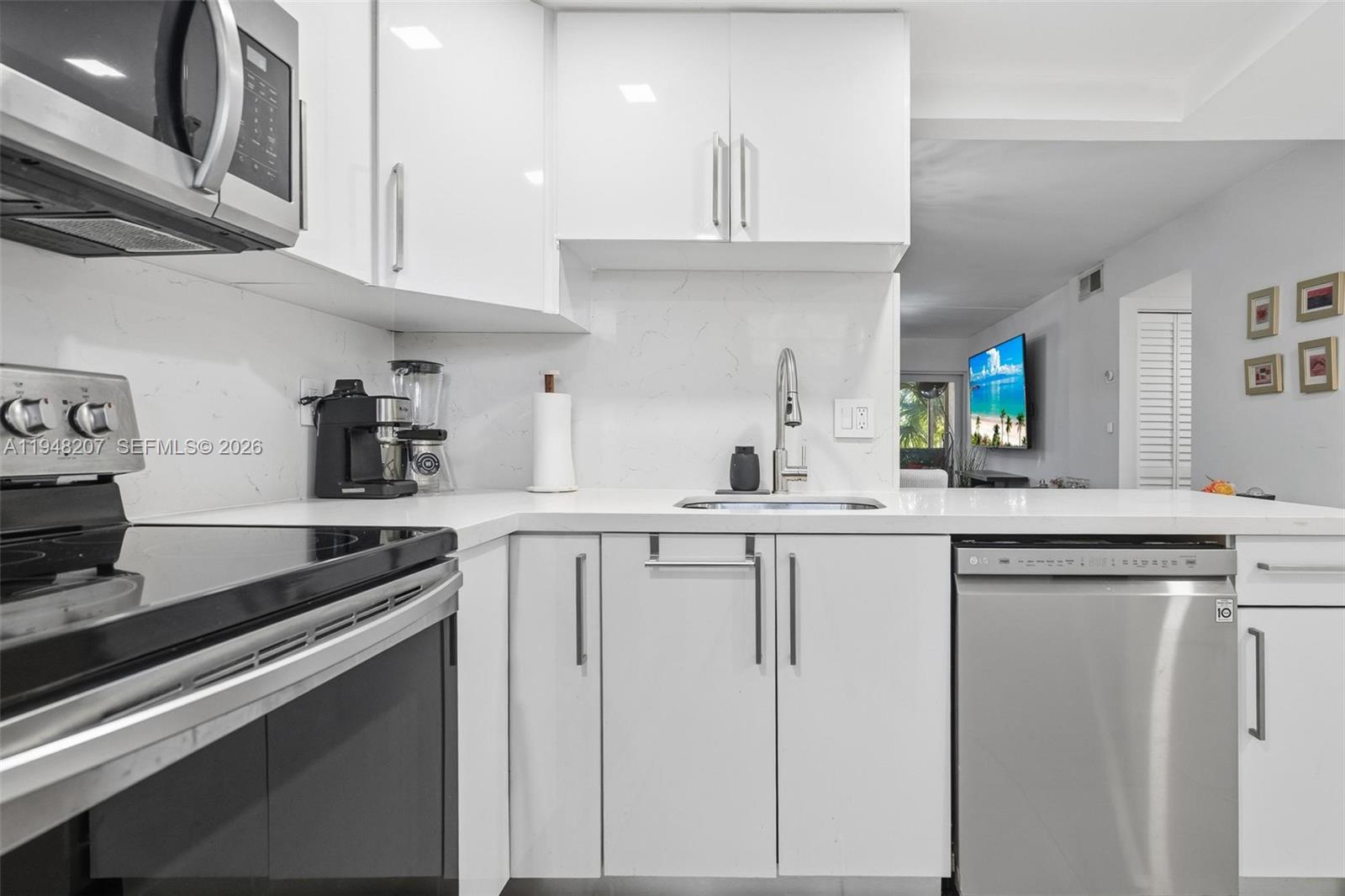 469 North Pine Island Road, Unit B302 Plantation, FL 33324 - Photo 10 of 33 a kitchen with stainless steel appliances white cabinets and a sink