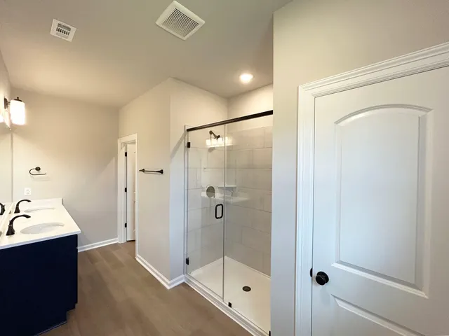 a bathroom with a shower and a sink