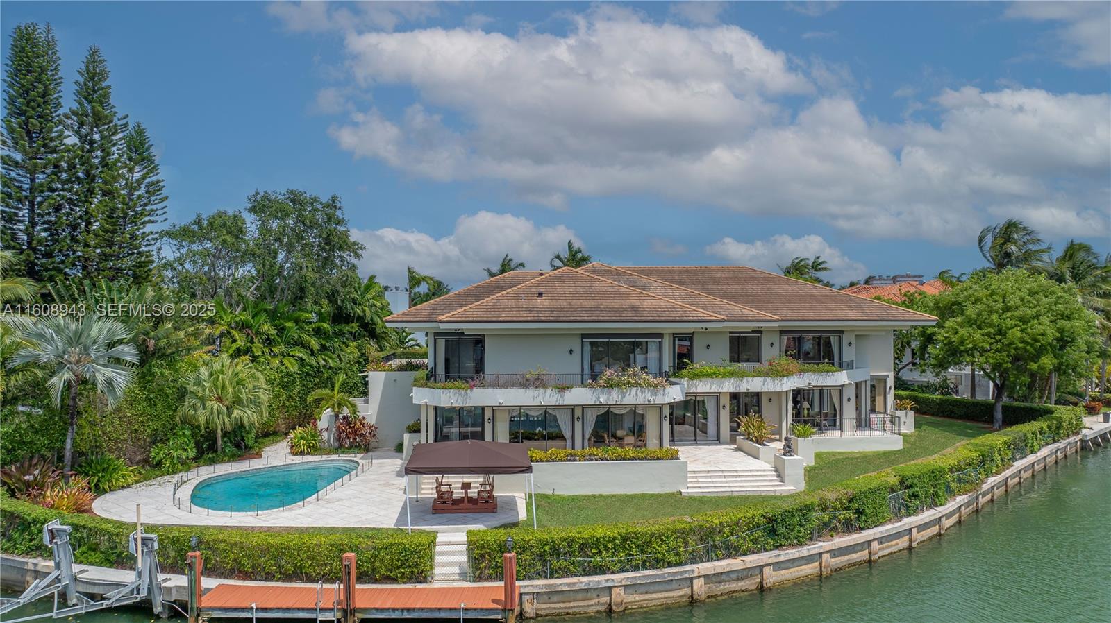 241 Cape Florida Drive Key Biscayne, FL 33149 - Photo 1 of 100 a front view of a house with a yard