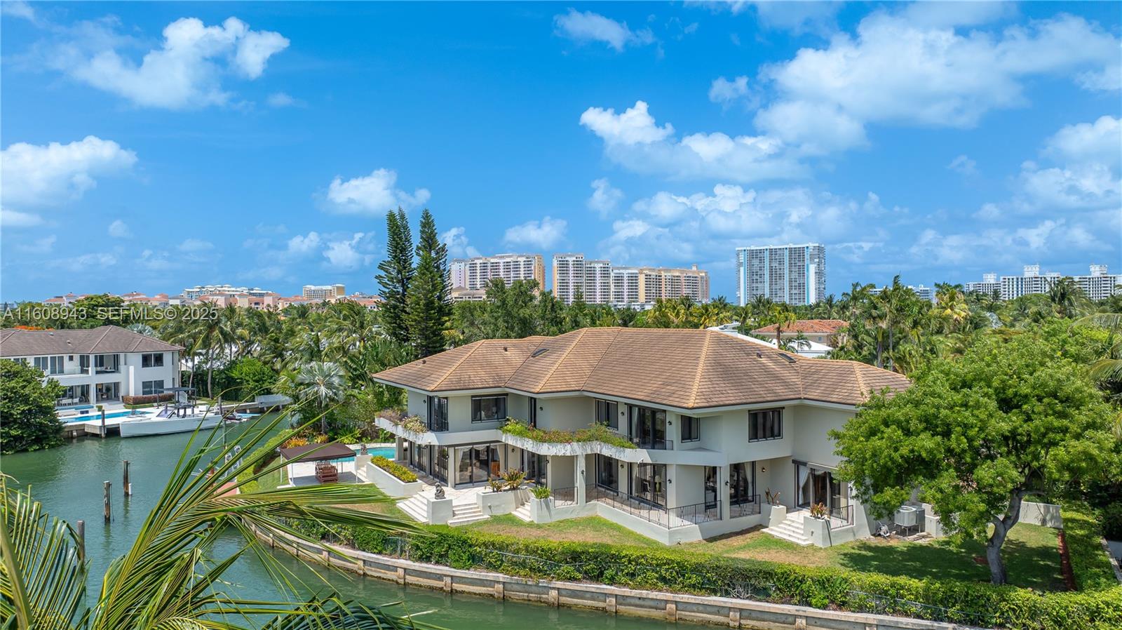 241 Cape Florida Drive Key Biscayne, FL 33149 - Photo 11 of 100 a front view of a house with a garden and lake view