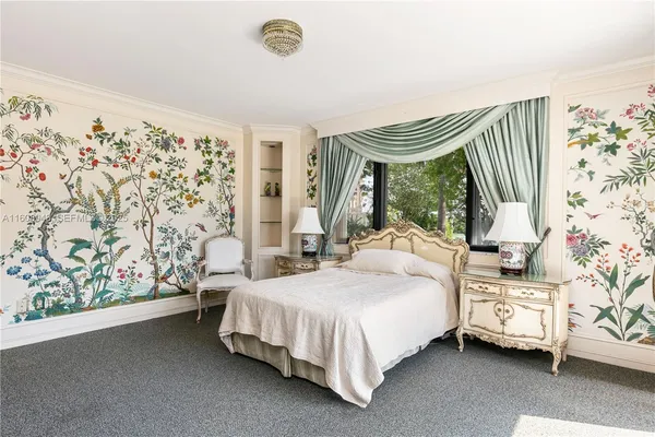 a spacious bedroom with a bed and cabinet