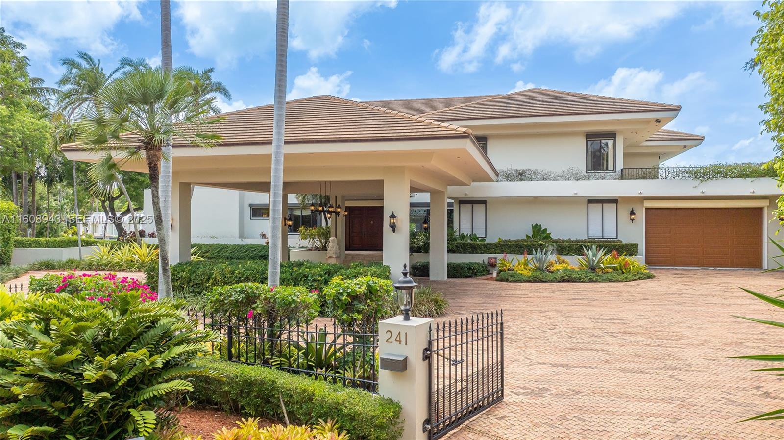 241 Cape Florida Drive Key Biscayne, FL 33149 - Photo 4 of 100 a front view of a house with a porch