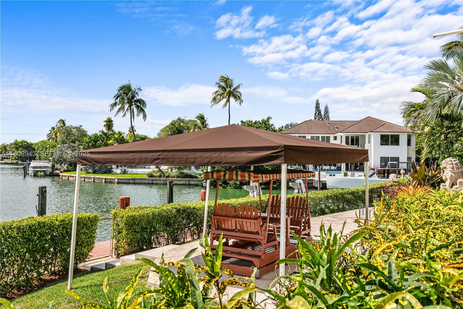 241 Cape Florida Drive Key Biscayne, FL 33149 - Photo 44 of 100 a front view of a house with a yard and potted plants