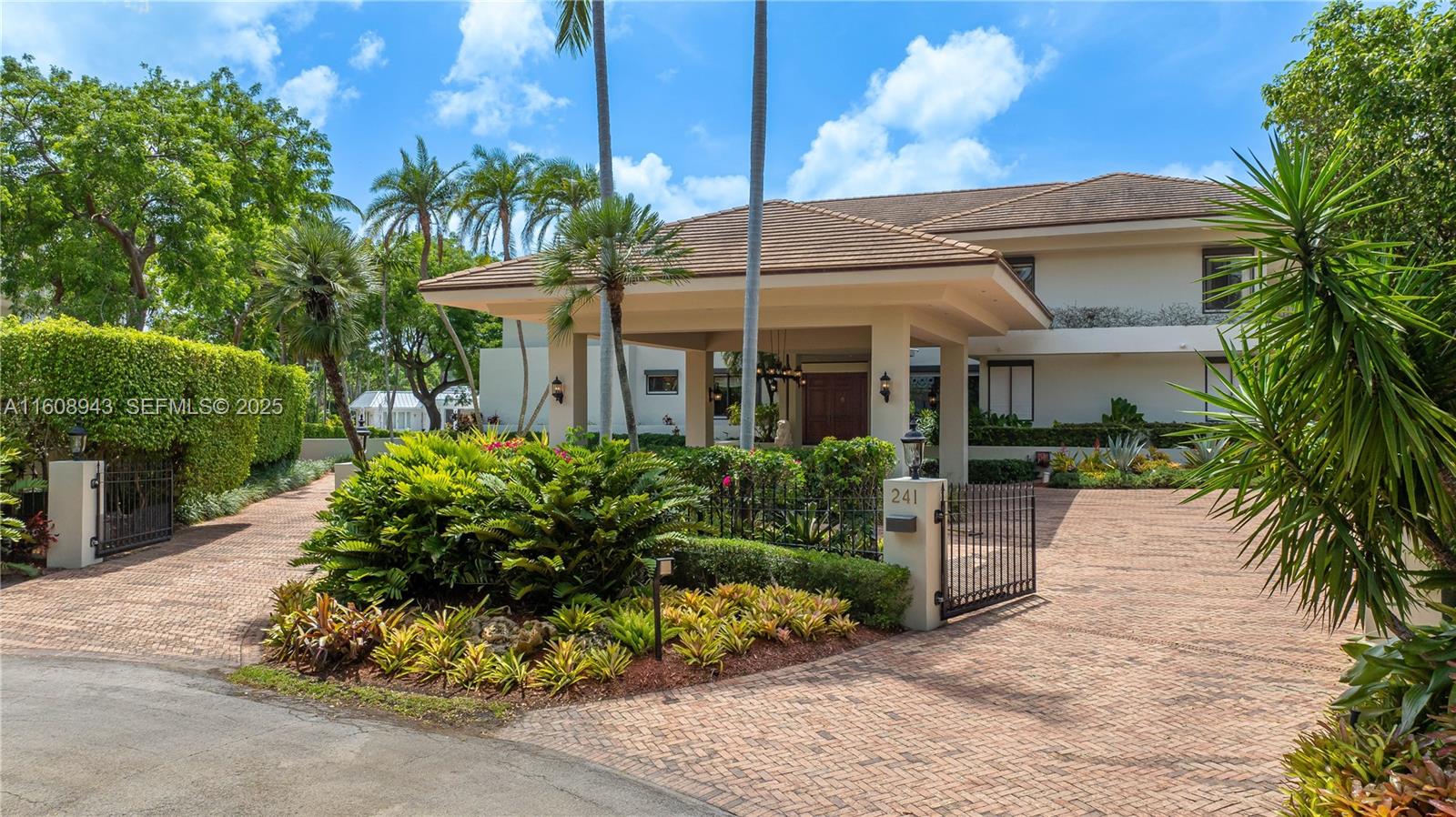 241 Cape Florida Drive Key Biscayne, FL 33149 - Photo 5 of 100 a front view of a house with a garden