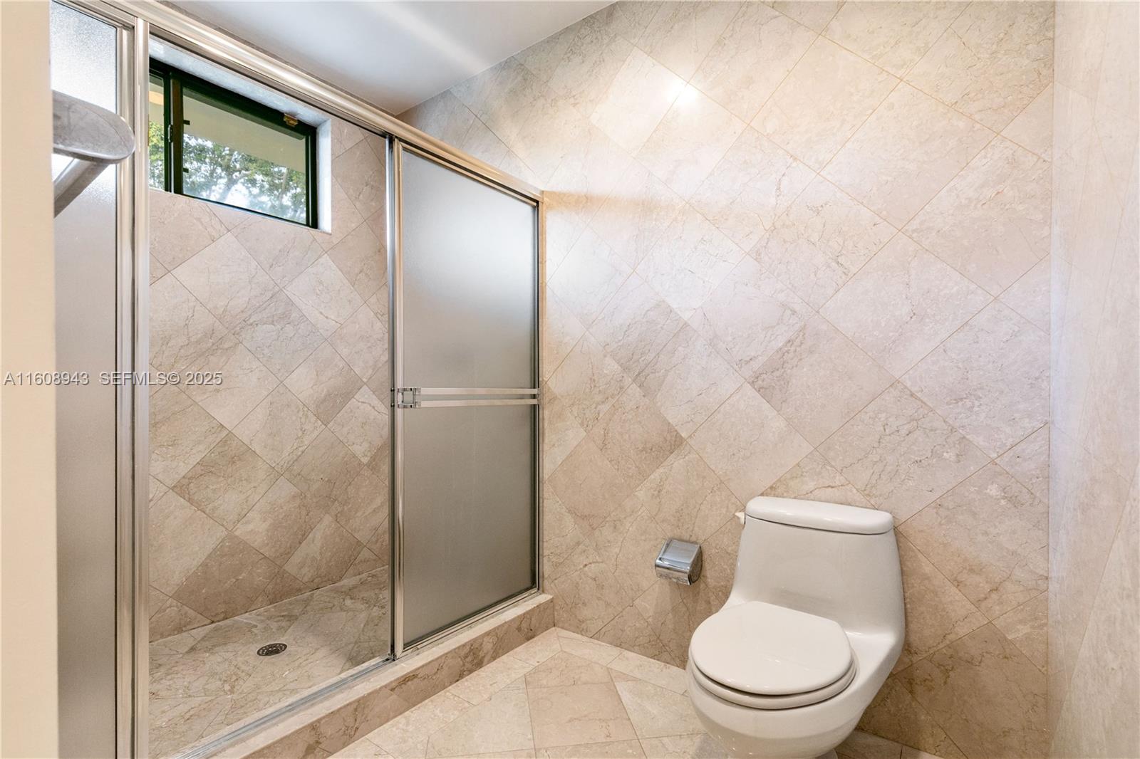 241 Cape Florida Drive Key Biscayne, FL 33149 - Photo 73 of 100 a white toilet sitting next to a bathroom sink