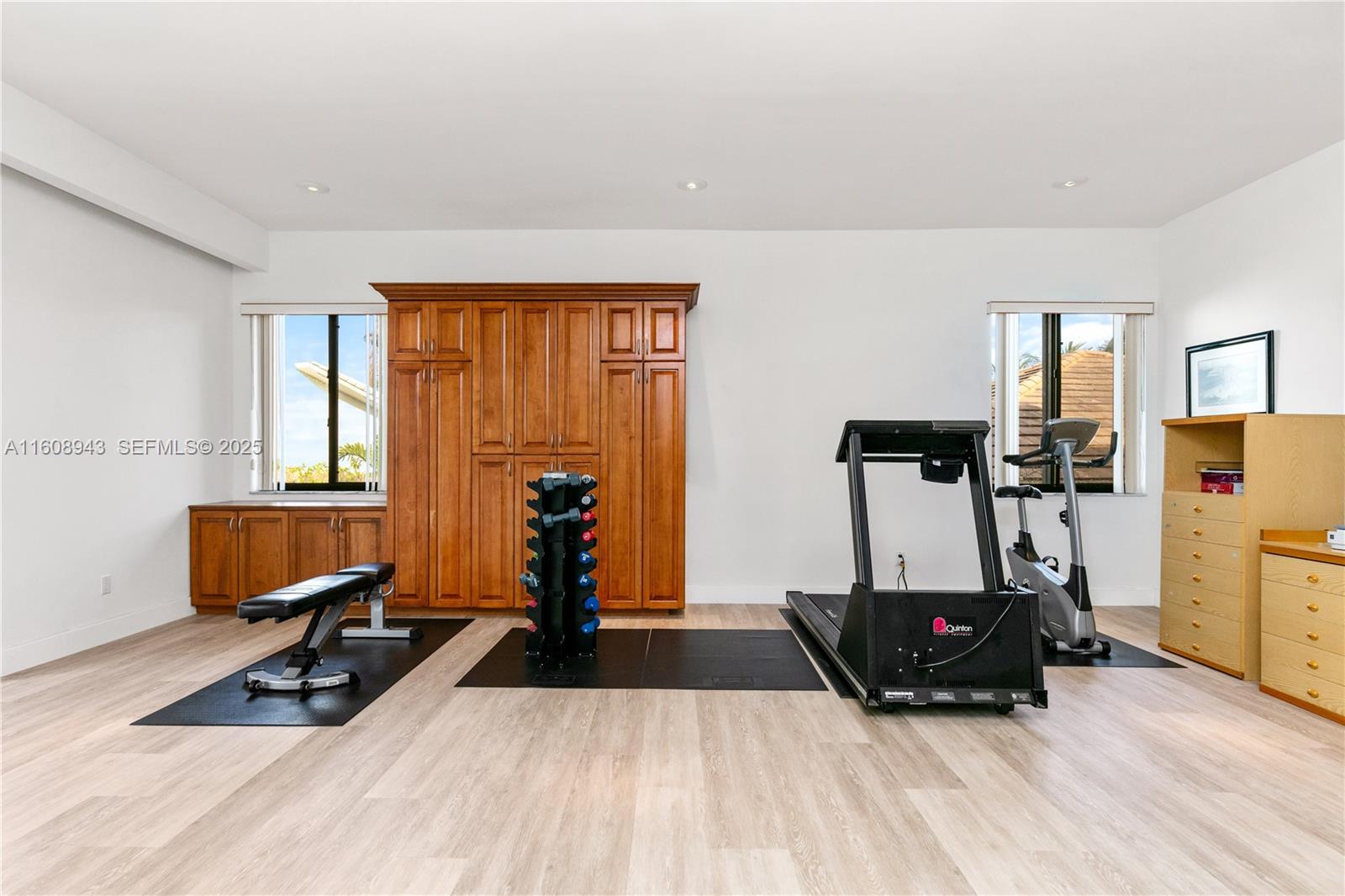 241 Cape Florida Drive Key Biscayne, FL 33149 - Photo 74 of 100 a room with gym equipment and a wooden floor