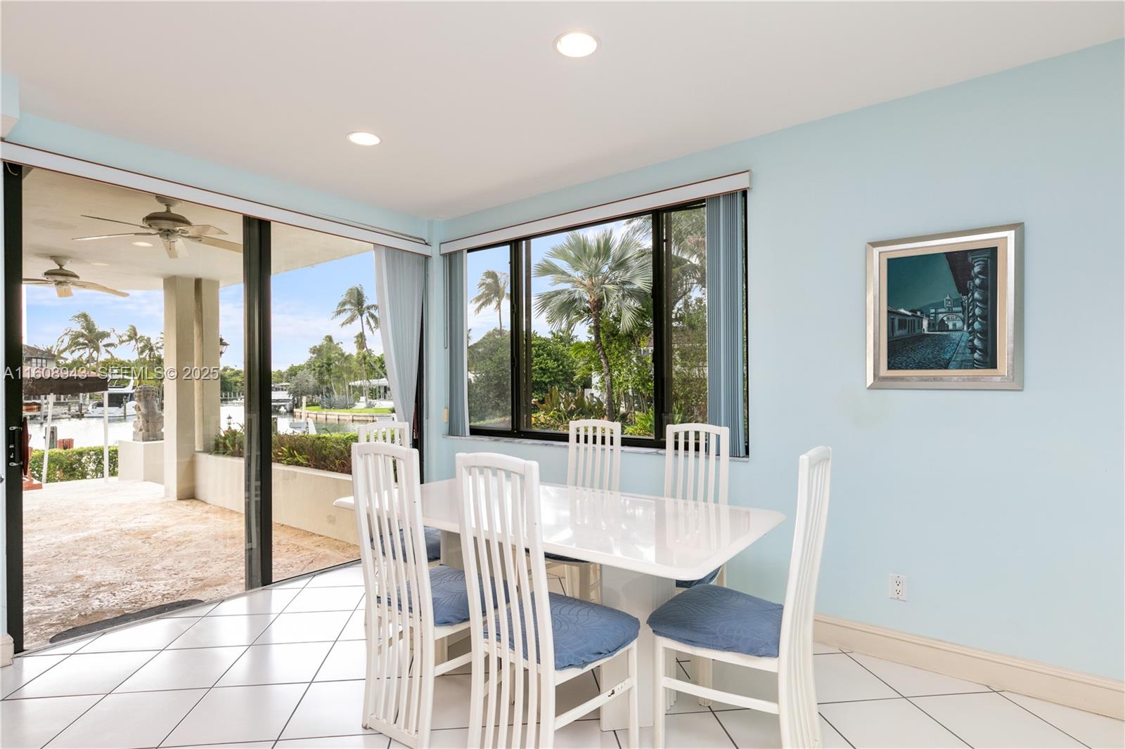 241 Cape Florida Drive Key Biscayne, FL 33149 - Photo 78 of 100 a dining room with wooden floor and glass door