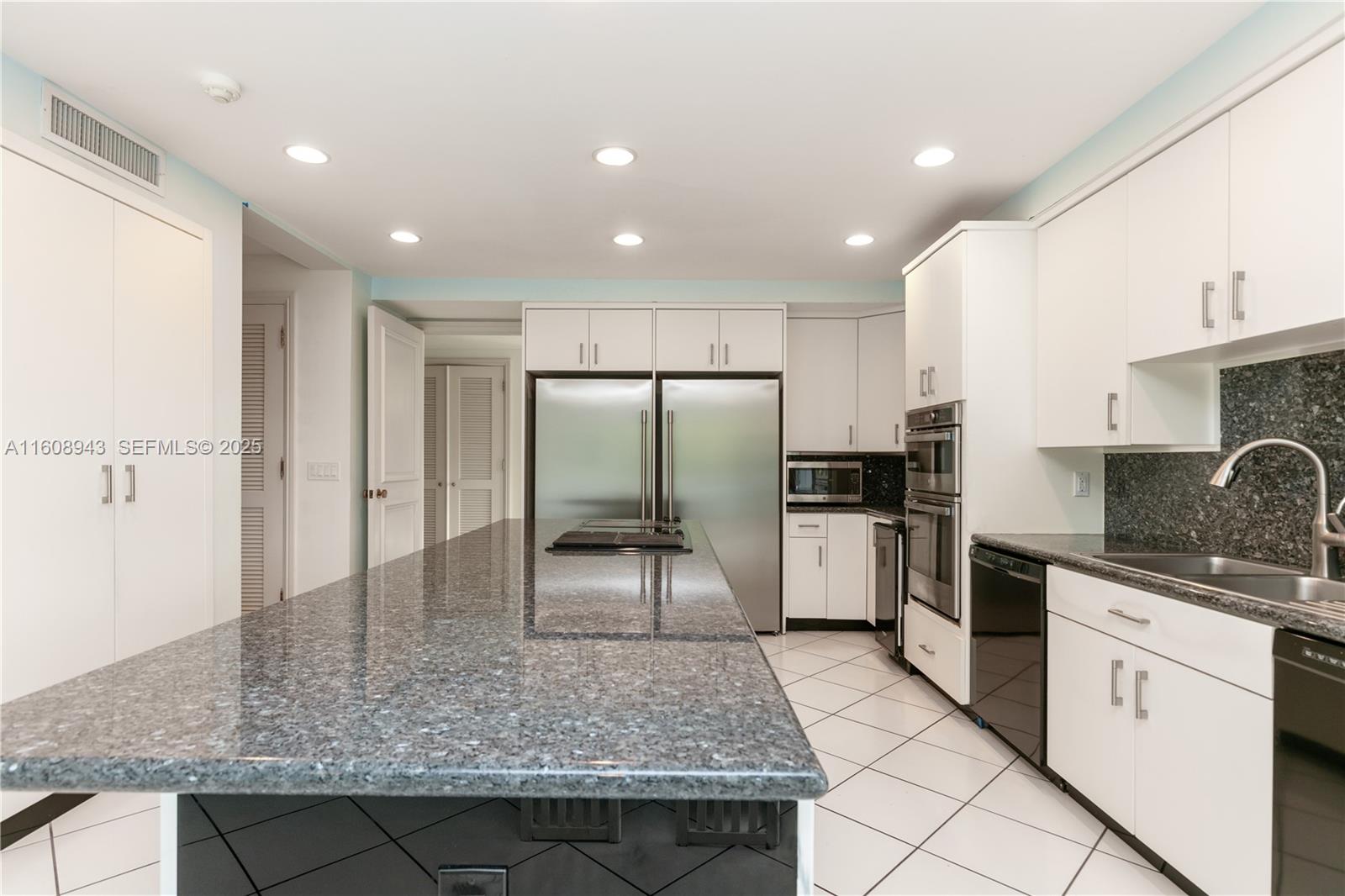 241 Cape Florida Drive Key Biscayne, FL 33149 - Photo 80 of 100 a kitchen with a sink stainless steel appliances and cabinets