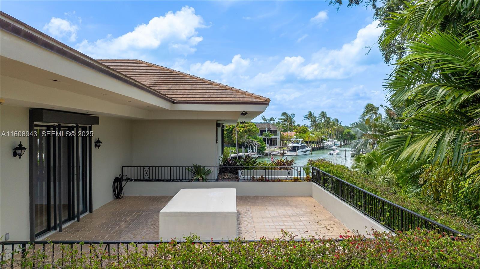 241 Cape Florida Drive Key Biscayne, FL 33149 - Photo 99 of 100 a view of a patio with table and chairs with wooden fence