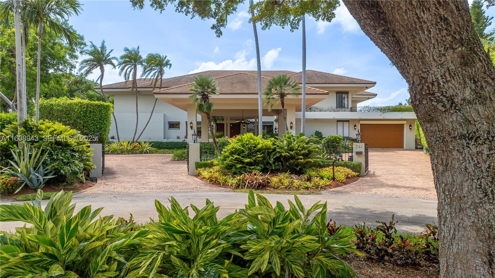 241 Cape Florida Drive Key Biscayne, FL 33149 - Photo 100 of 100 a front view of a house with a yard