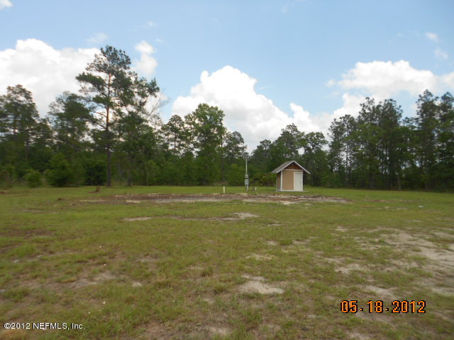 1463 Long Bay Road Middleburg, FL 32068 - Photo 1 of 6 a view of a field with an tree in the background