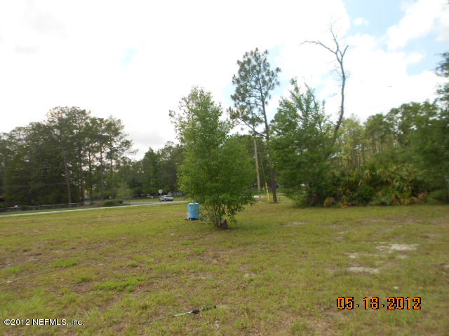 1463 Long Bay Road Middleburg, FL 32068 - Photo 3 of 6 a view of a field with an trees in the background