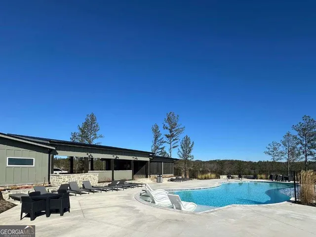 a view of a patio with dining table and chairs