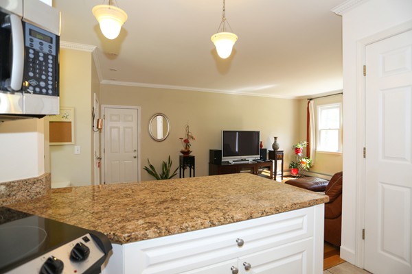 3 E Road Wayland, MA 01778 - Photo 12 of 24 a kitchen with stainless steel appliances granite countertop a sink and a white cabinets