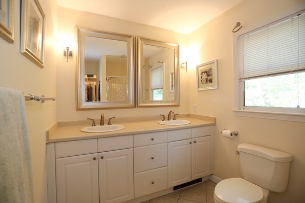 3 E Road Wayland, MA 01778 - Photo 20 of 24 a bathroom with a toilet sink and mirror