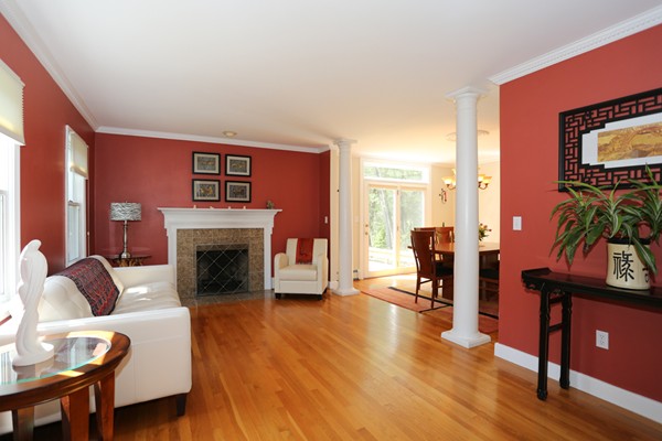 3 E Road Wayland, MA 01778 - Photo 6 of 24 a living room with furniture a flat screen tv and a fireplace