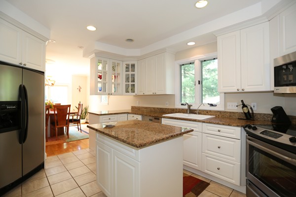 3 E Road Wayland, MA 01778 - Photo 9 of 24 a kitchen with a sink a stove a refrigerator and cabinets