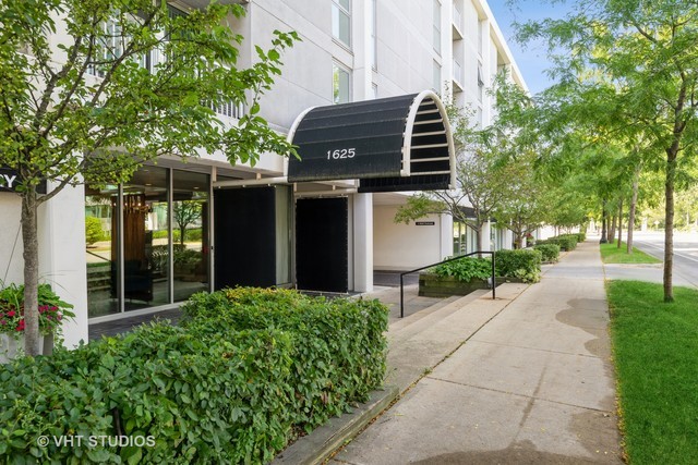 1625 Sheridan Road, Unit 213 Wilmette, IL 60091 - Photo 1 of 18 a front view of a building with garden