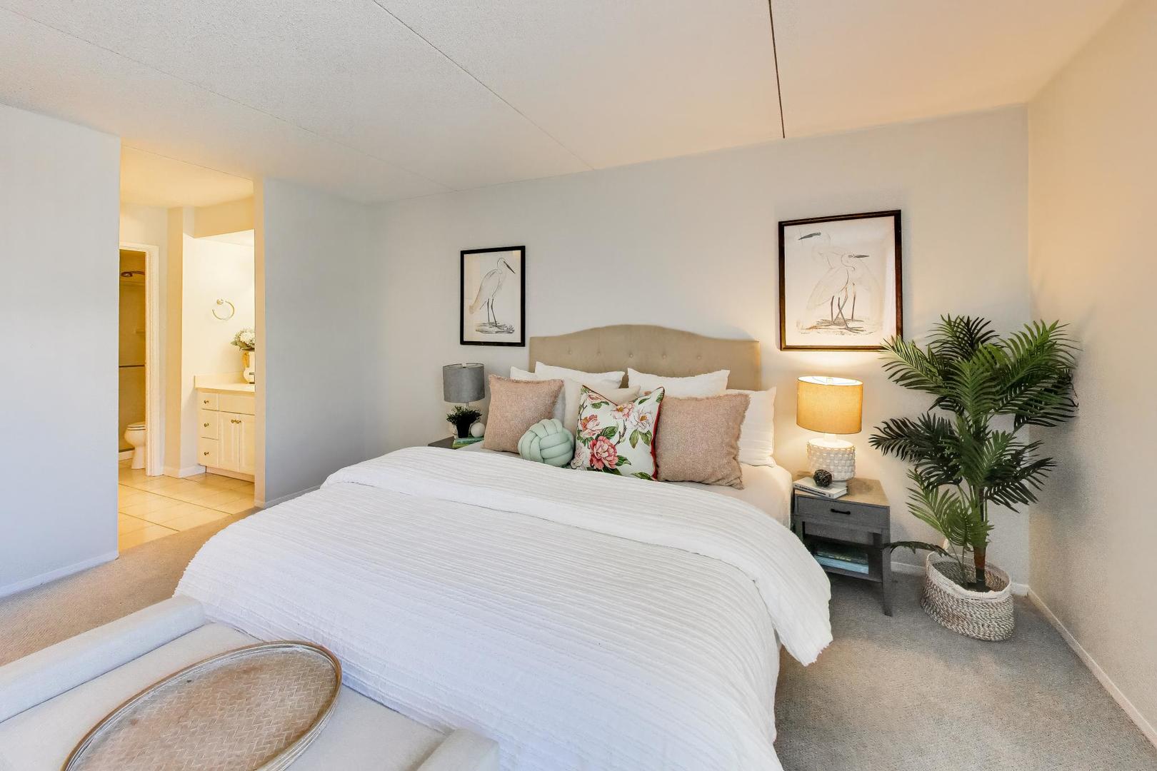 1625 Sheridan Road, Unit 213 Wilmette, IL 60091 - Photo 11 of 18 a bedroom with a bed lamp and a potted plant