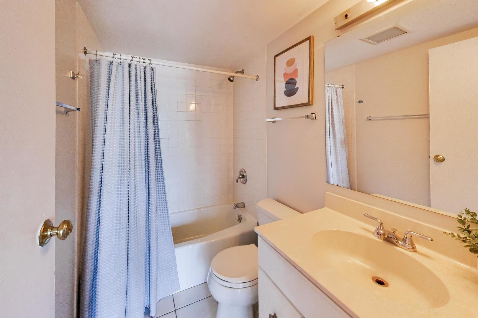 1625 Sheridan Road, Unit 213 Wilmette, IL 60091 - Photo 15 of 18 a bathroom with a granite countertop sink toilet and shower