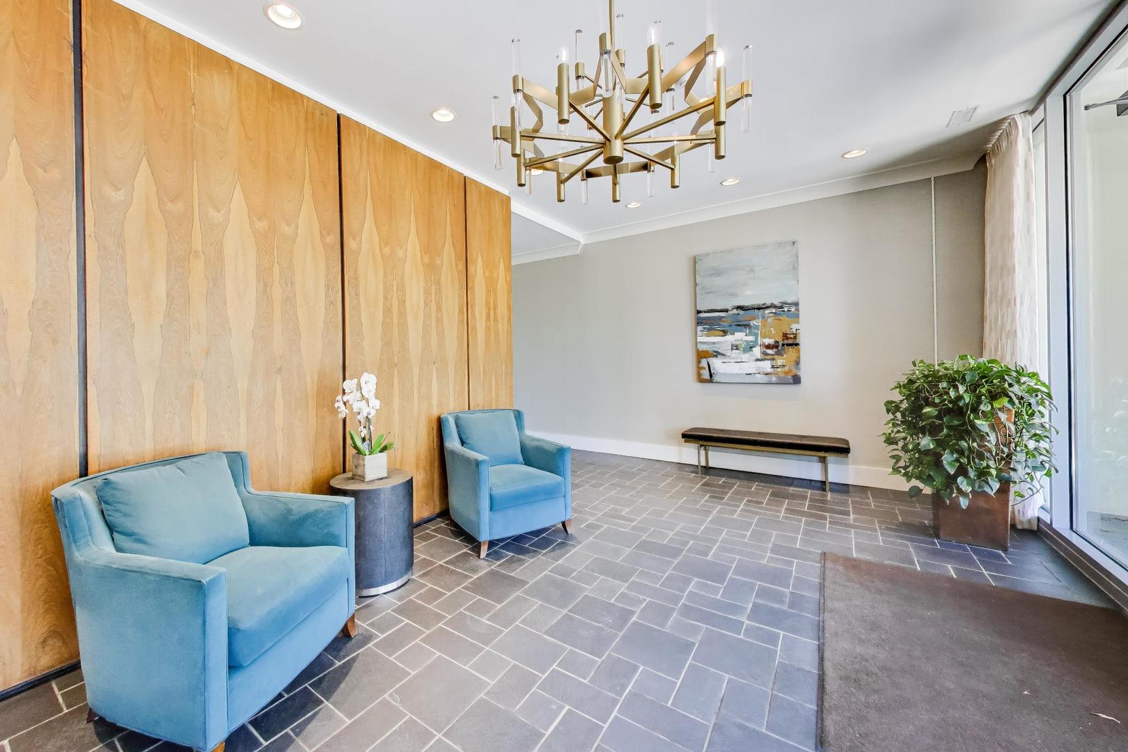 1625 Sheridan Road, Unit 213 Wilmette, IL 60091 - Photo 2 of 18 a living room with furniture and a chandelier