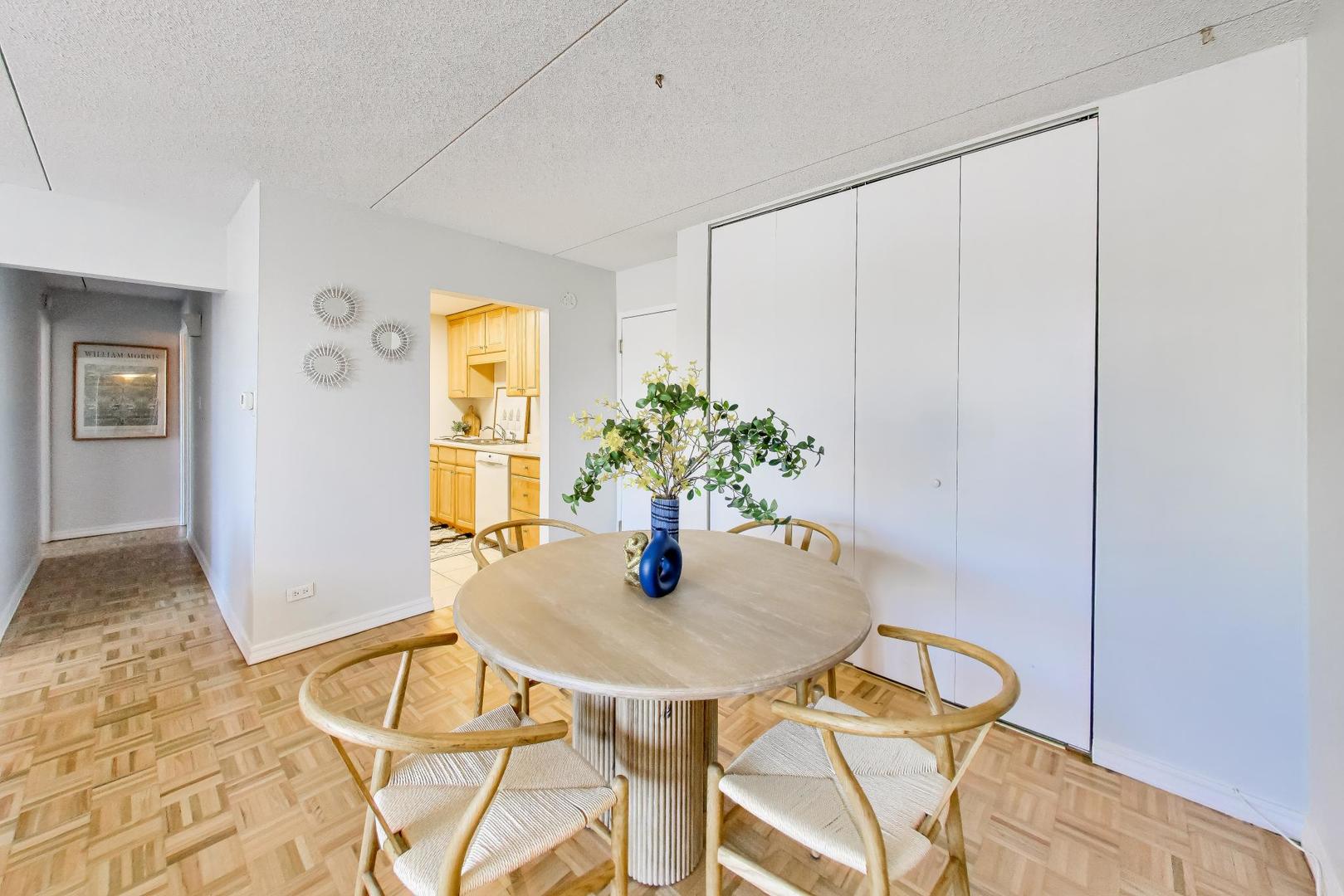 1625 Sheridan Road, Unit 213 Wilmette, IL 60091 - Photo 6 of 18 a dining room with furniture and wooden floor