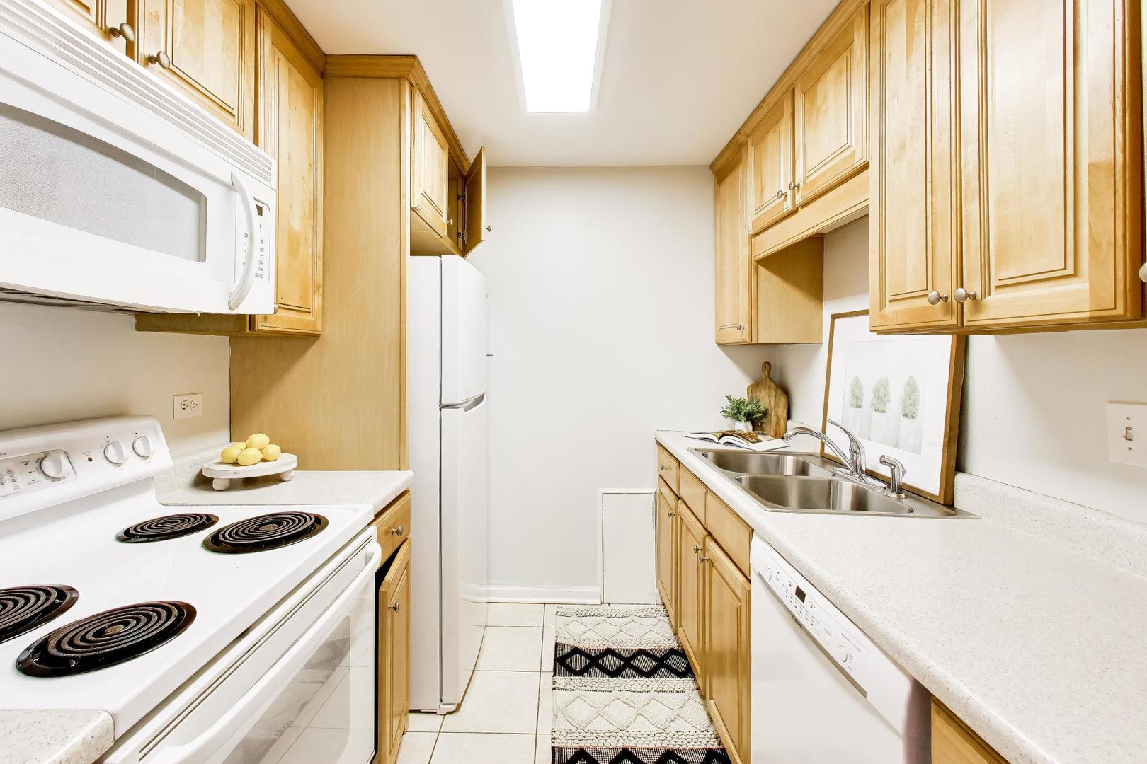 1625 Sheridan Road, Unit 213 Wilmette, IL 60091 - Photo 8 of 18 a kitchen with a sink a stove and a refrigerator