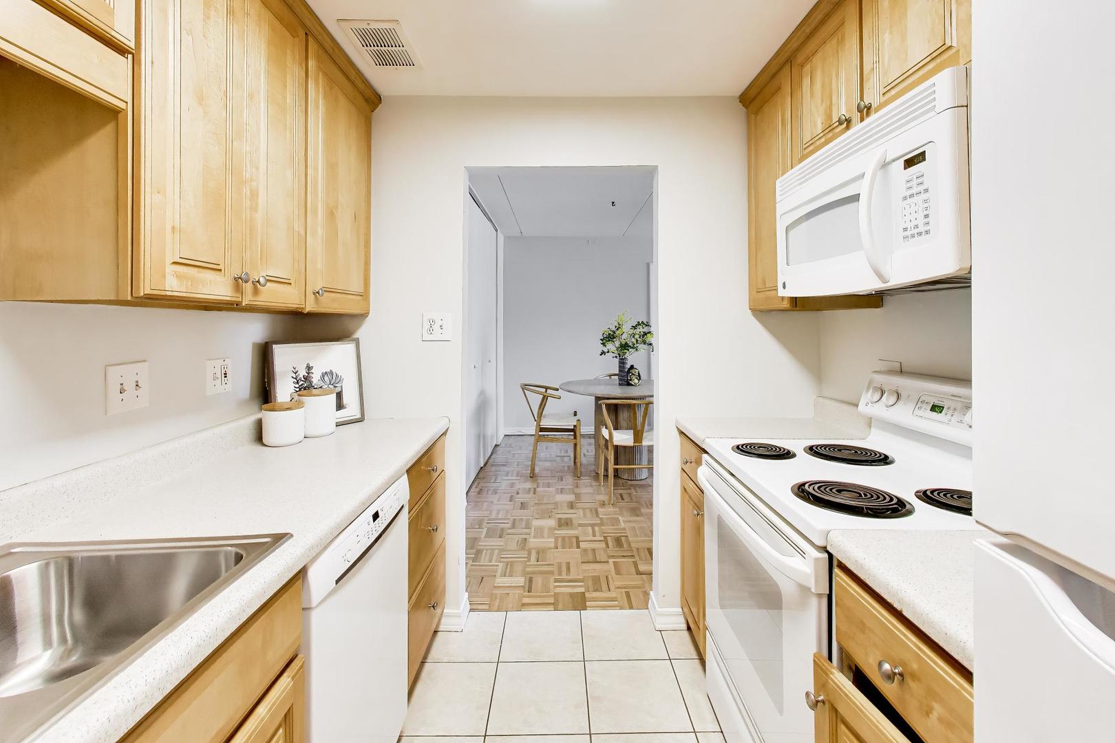 1625 Sheridan Road, Unit 213 Wilmette, IL 60091 - Photo 9 of 18 a kitchen with a sink a stove and cabinets