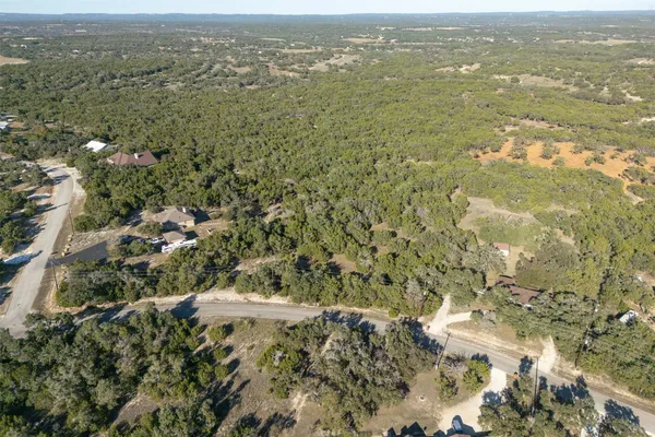 an aerial view of house with yard and mountain view in back