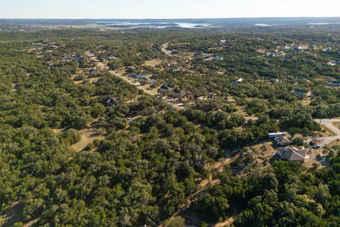 an aerial view of residential houses with outdoor and green space
