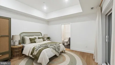 a bedroom with a bed and a mirror